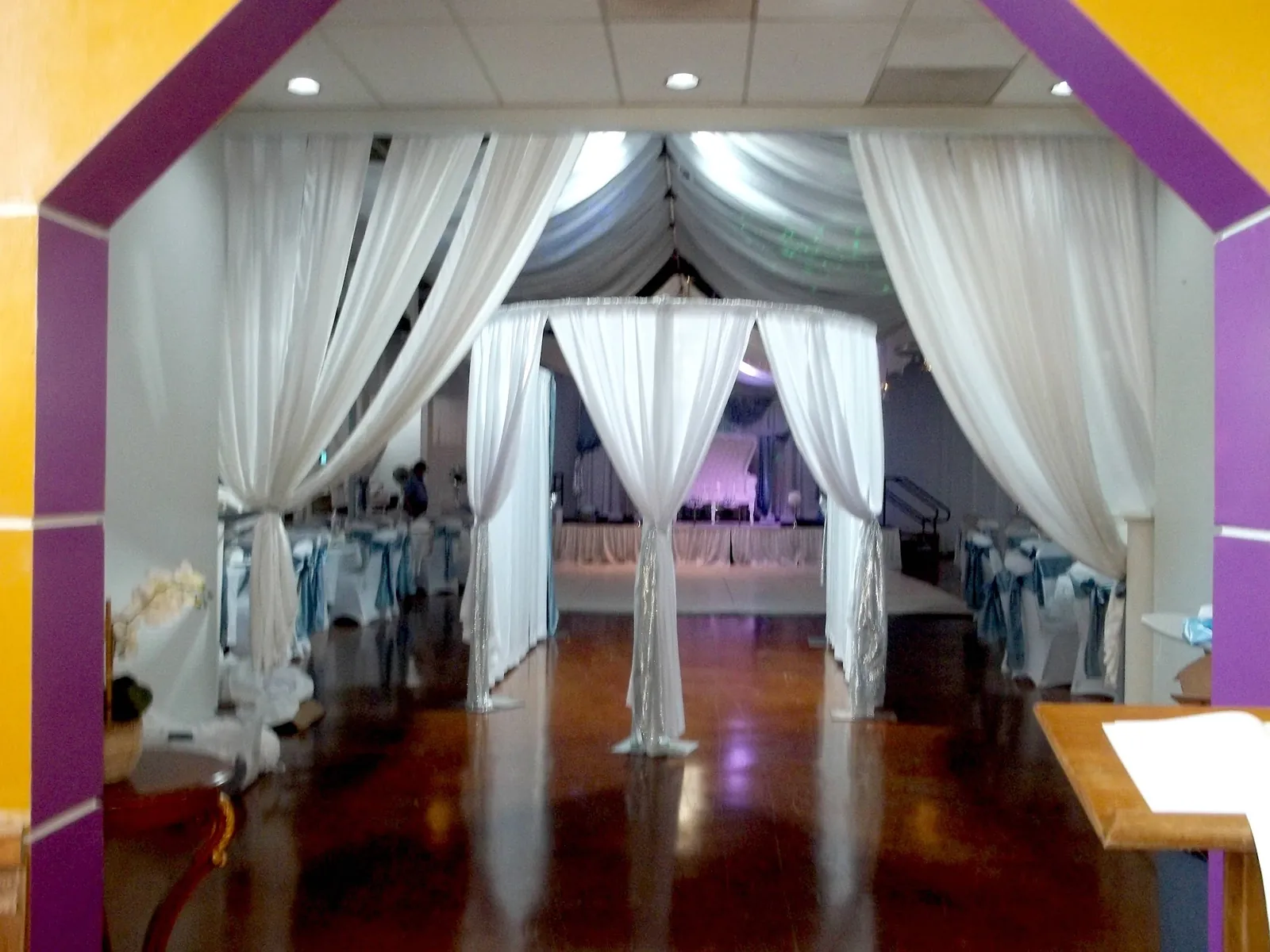 White fabric canopy draped over the ballroom floor