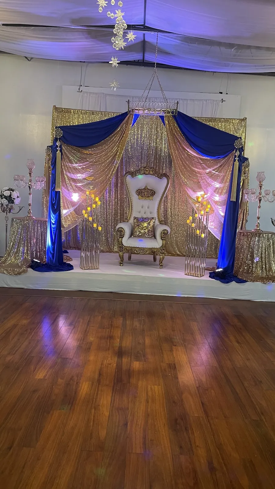 Royal blue and gold stage with a white throne