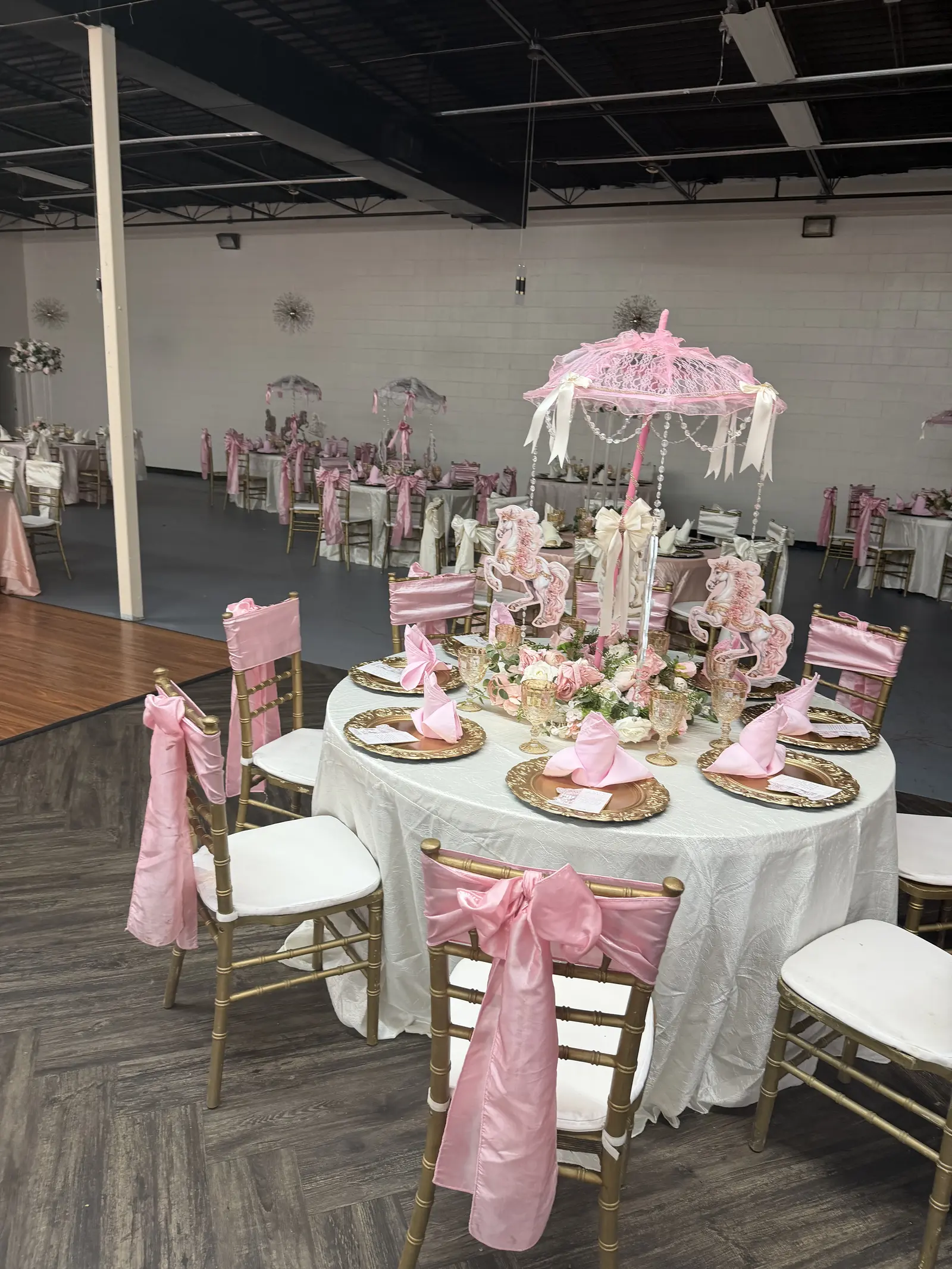 Detailed pink and gold table setting inside Golden Palace Ballroom